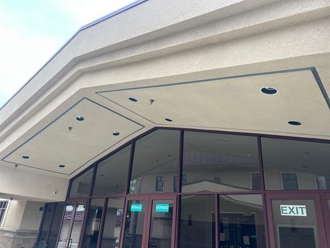 Commercial storefront soffit with recessed lights and a glass storefront