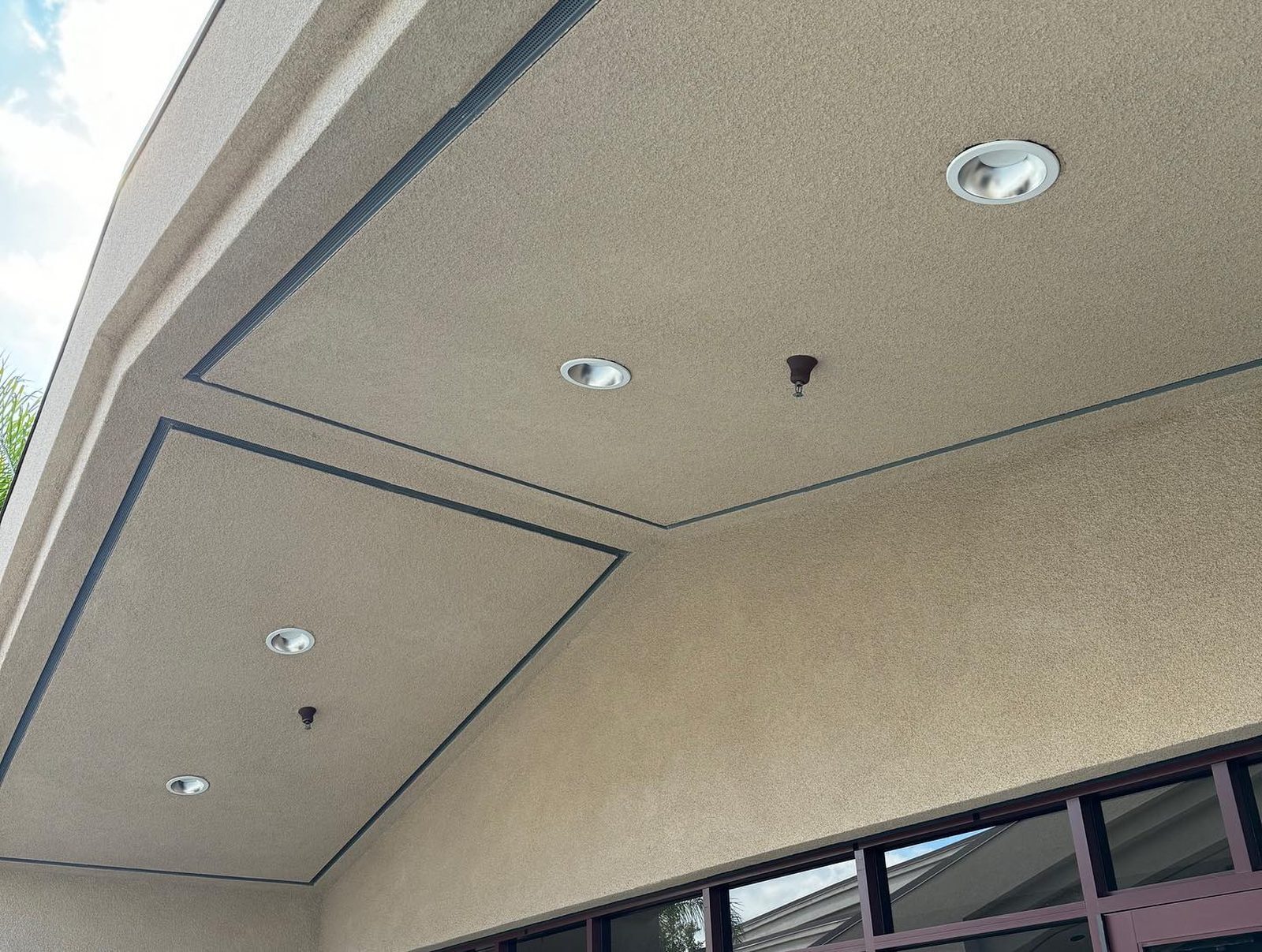 Close view of recessed lights in a commercial storefront soffit