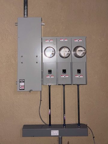New three-meter commercial service with disconnects on a beige wall