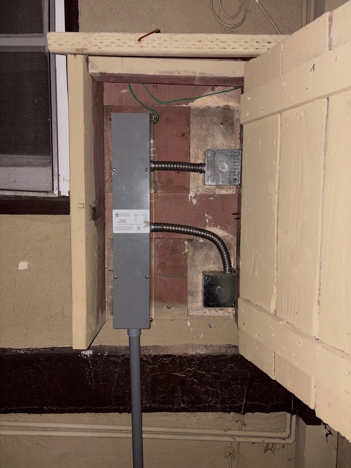 New panel and conduit inside a wall cut during relocation