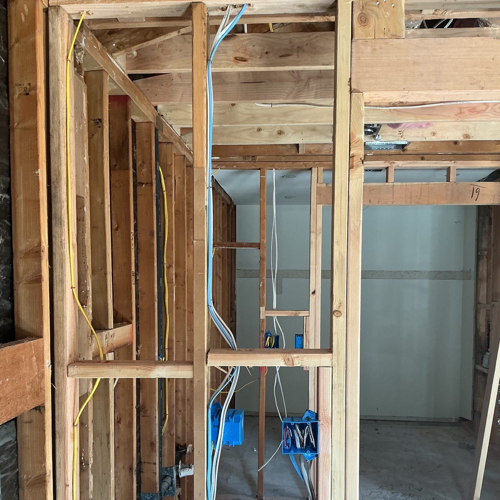 Remodel rough-in with blue boxes and cable through studs