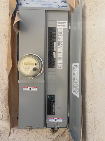 New 200-amp main panel and meter on a stucco wall in Long Beach