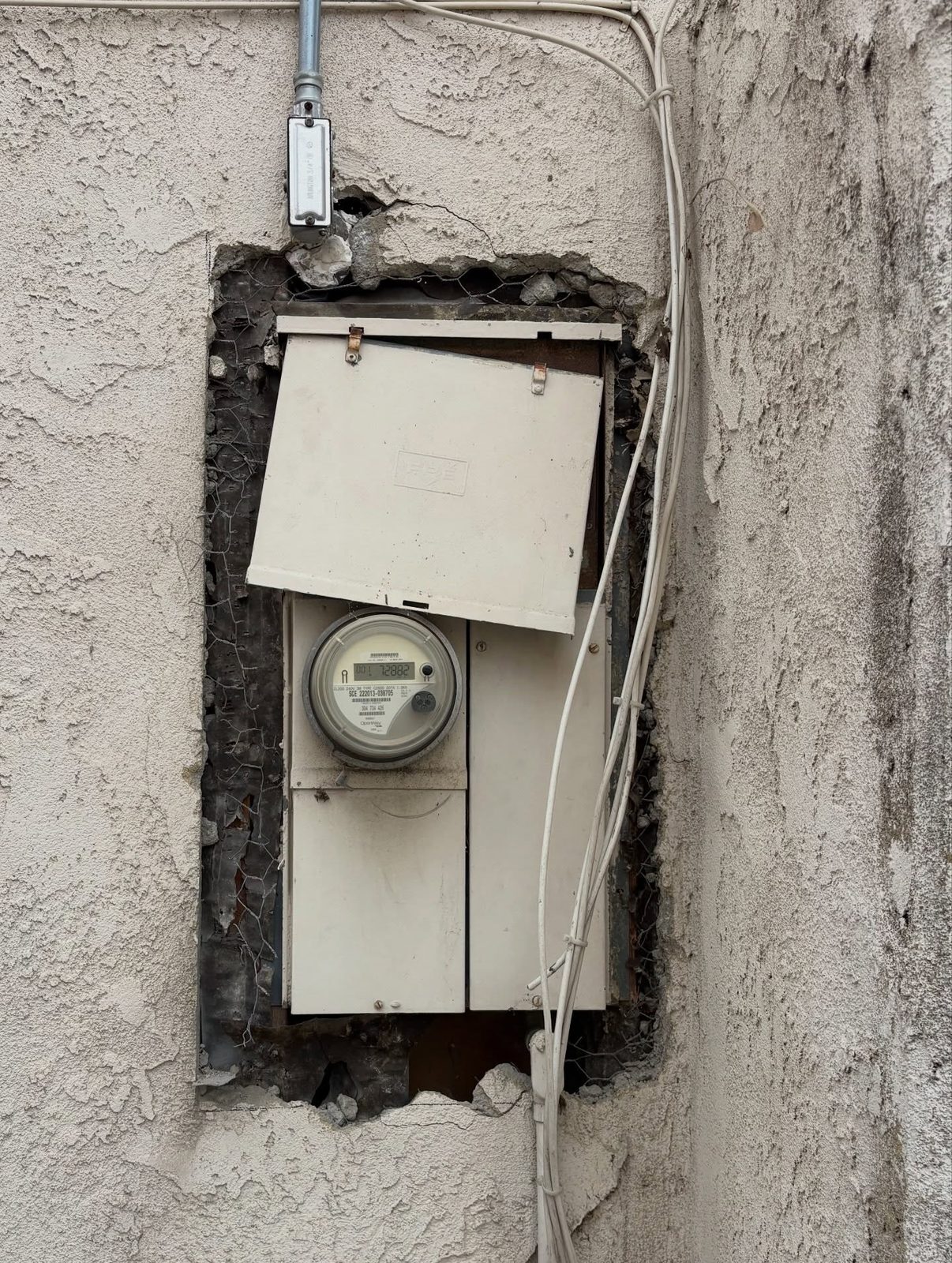 Old panel torn out of a stucco wall during replacement