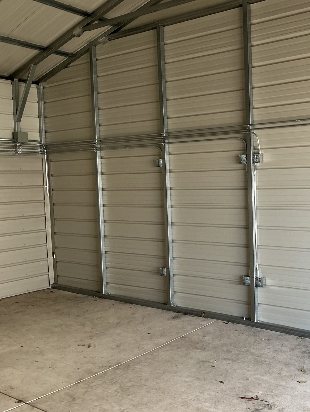 EMT conduit runs along the wall of a metal building